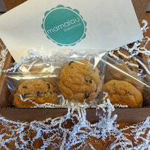 Load image into Gallery viewer, Cookies packed individually in plastic sitting inside a shipping boxed stuffed with packing paper.
